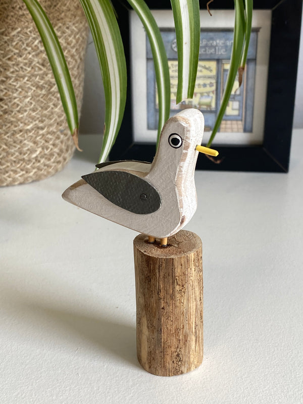 Little Wooden Seagull on Log